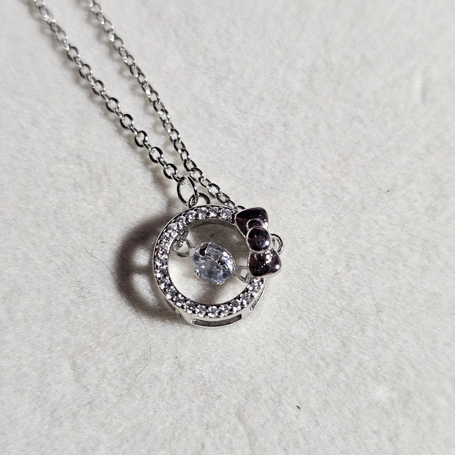 SILVER CIRCLE WITH BOW NECKLACE