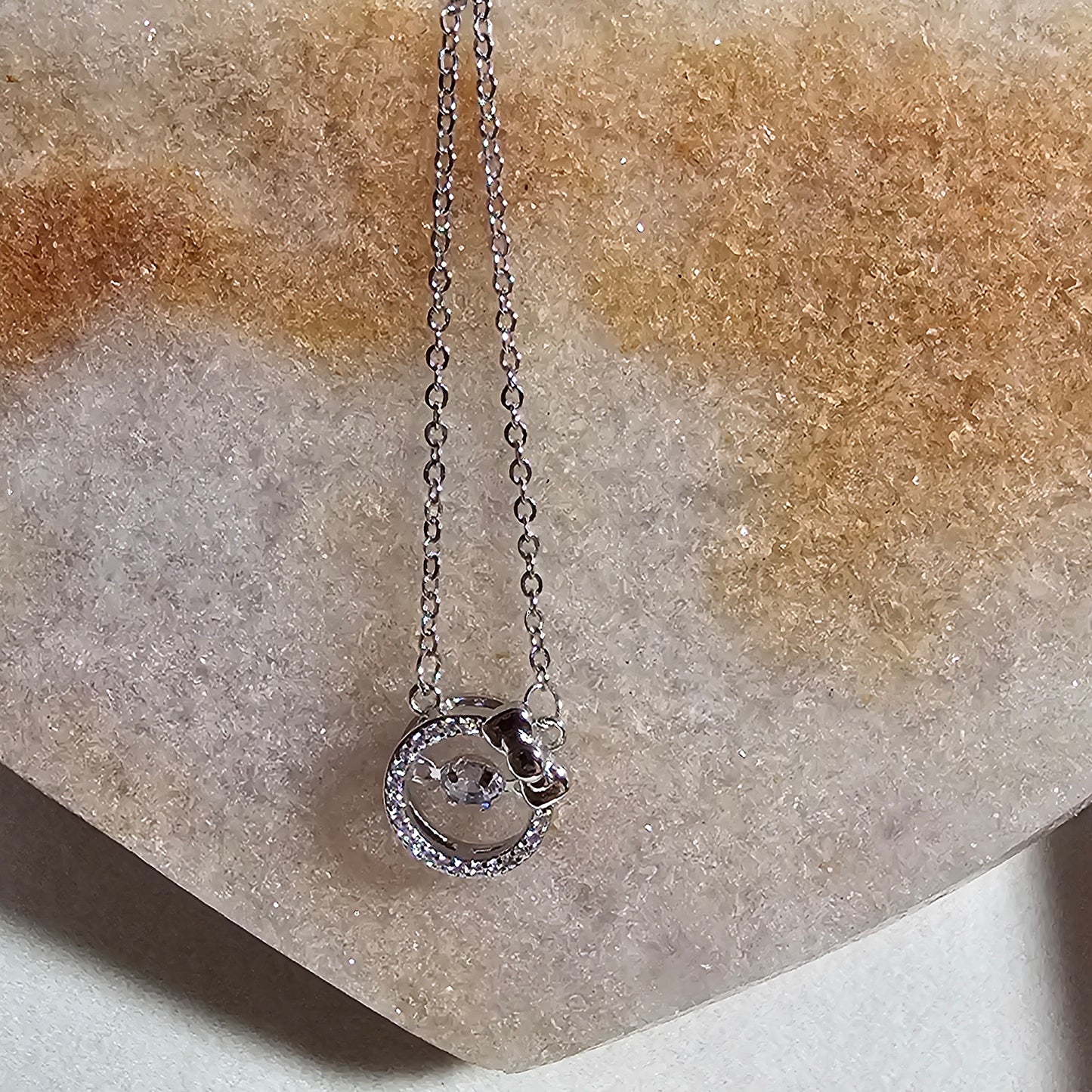SILVER CIRCLE WITH BOW NECKLACE